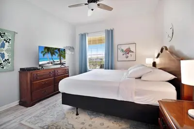 a bedroom with a bed and a dresser and a window at 3 Bed Penthouse Near Convention Center! condo in Orlando