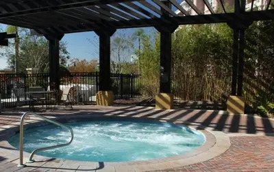 a hot tub in a patio with a gazebo at 3 Bed Penthouse Near Convention Center! condo in Orlando