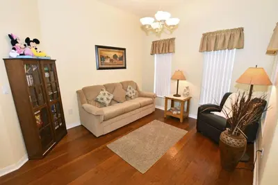 a living room with a couch and a chair at Lakeside 4-Bed Pool Home at Villa Sol home in Kissimmee