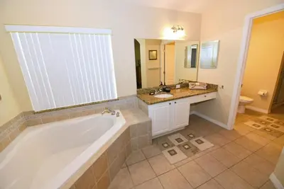 a large bathroom with a tub and a sink at Lakeside 4-Bed Pool Home at Villa Sol home in Kissimmee