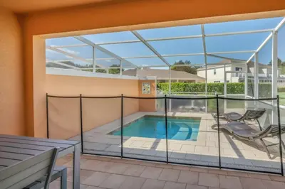 a balcony with a view of a swimming pool at 1511RETREAT townhouse in Orlando