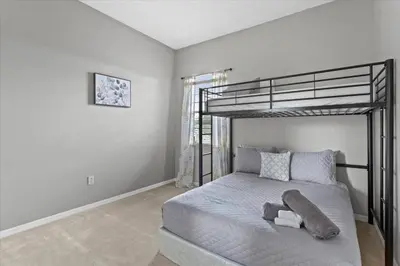 a bedroom with a bunk bed with a teddy bear on it at LONG STAYS! Lakefront - Gated Pool Home in Orlando