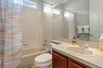 a bathroom with a sink and a toilet and a shower at LONG STAYS! Lakefront - Gated Pool Home in Orlando