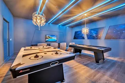 a room with a ping pong table and a pool table at 8 Bedroom 6 Bathroom Resort Home villa in Kissimmee