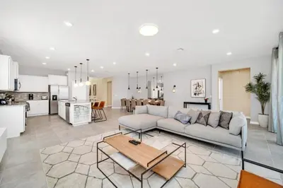 a white living room with a couch and a table at 8 Bedroom 6 Bathroom Resort Home villa in Kissimmee