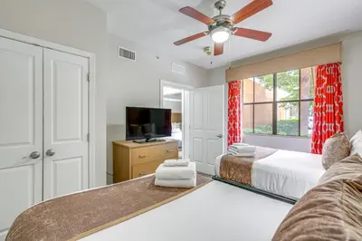 a bedroom with two beds and a flat screen tv at Disney Good Neighbor Resort Condo Less Than 4 Mi to WDW! in Orlando