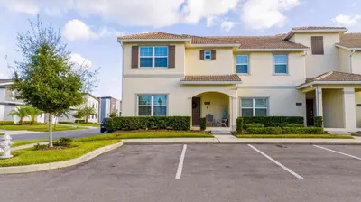 a house with a parking lot in front of it at Magnificent 5Bd w/ Pool Close to Disney @Storey Lake 4800 in Kissimmee