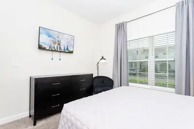 a bedroom with a bed and a dresser and a window at Magnificent 5Bd w/ Pool Close to Disney @Storey Lake 4800 in Kissimmee