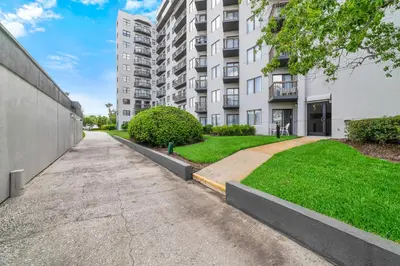 an empty sidewalk in front of a apartment building at Fabulous Resort Condo with Heated Pool! in Orlando