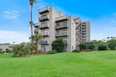a large apartment building with a green lawn at Fabulous Resort Condo with Heated Pool! in Orlando