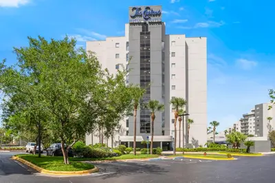a large white building with a sign on it at Fabulous Resort Condo with Heated Pool! in Orlando