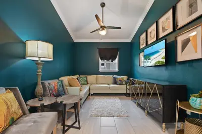 a living room with blue walls and a couch at Best Location Pet Friendly Fenced Yard in Orlando