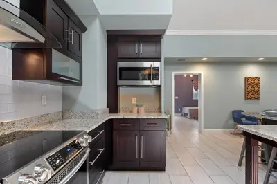 a kitchen with dark wood cabinets and granite counter tops at Best Location Pet Friendly Fenced Yard in Orlando