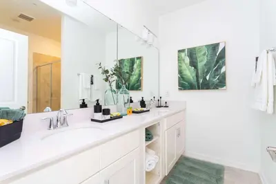 a white bathroom with a sink and a mirror at Gorgeous 2Bd Apto Close to Disney @ Storey Lake 404 3191 in Kissimmee