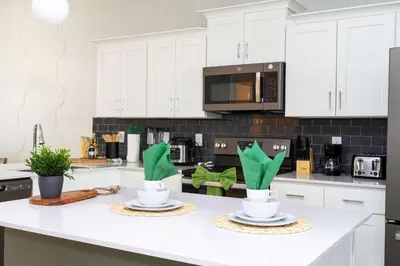 a kitchen with white cabinets and white counter tops at Gorgeous 2Bd Apto Close to Disney @ Storey Lake 404 3191 in Kissimmee