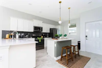 a kitchen with white cabinets and white counter tops at Gorgeous 2Bd Apto Close to Disney @ Storey Lake 404 3191 in Kissimmee