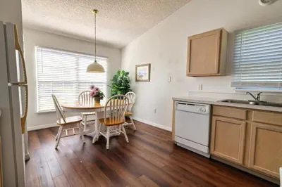 a kitchen with a table and chairs in a kitchen at Clear Creek 3 Bedroom Home Private Pool 15 Min to Disney in Orlando