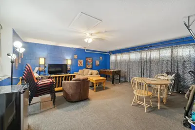 a living room with blue walls and a couch and a table at Vacation Resort Home Right Outside of Disney World Parks with Private Pool home in Kissimmee