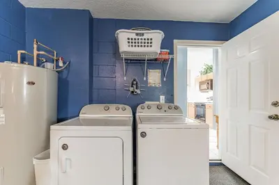 a kitchen with white appliances and a blue wall at Vacation Resort Home Right Outside of Disney World Parks with Private Pool home in Kissimmee