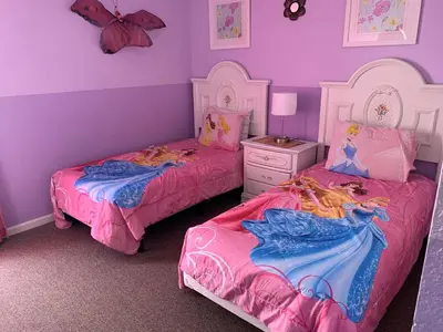 two beds in a girls bedroom with purple walls at Windsor Hill Resort Home w Pool, 5 Min from Disney in Orlando