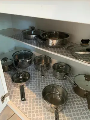 a kitchen with many pots and pans on a counter at Windsor Hill Resort Home w Pool, 5 Min from Disney in Orlando