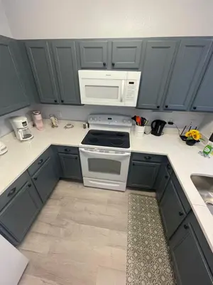 a kitchen with gray cabinets and a white microwave at Home sweet Home near Disneyland in Kissimmee