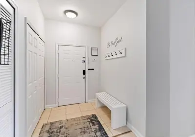 a white hallway with a white door and a rug at Making Memories At Windsor Palms Resort, Great Amenities And Much More Fun! in Kissimmee
