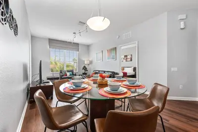 a dining room and living room with a table and chairs at Vista Cay Resort in Orlando