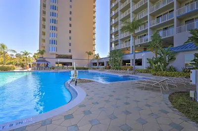 a swimming pool in front of a building at 1 Mi to Disney Condo with Water-View Balcony! in Orlando