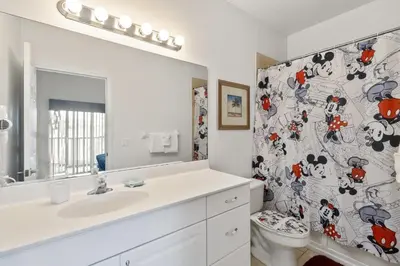 a bathroom with a white sink and a toilet at Huge Screened Patio That Overlooks Lake Buck, Near Famous Attractions!! in Orlando