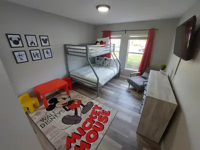 a small room with a bunk bed and a rug at Amazing 32 Condo, Gated Community At Club Cortile!! in Kissimmee