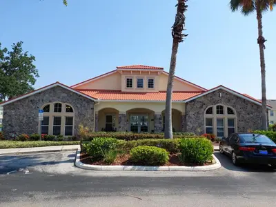 a house with a car parked in front of it at Amazing 32 Condo, Gated Community At Club Cortile!! in Kissimmee