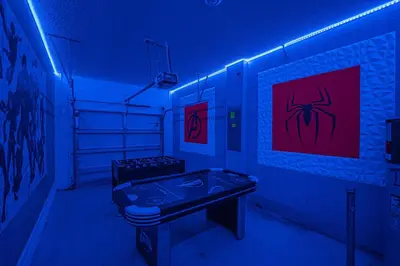 a blue room with a table in a room with a spider painting at Storey Lake Resort, Private Pool, And Much More!! in Kissimmee