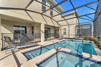 a swimming pool with a patio and a house at Storey Lake Resort, Private Pool, And Much More!! in Kissimmee