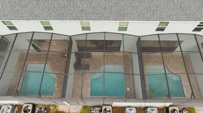 an external view of a building with glass windows at 1798 TP - 4BR Luxury Solara Retreat Pool Disney in Orlando