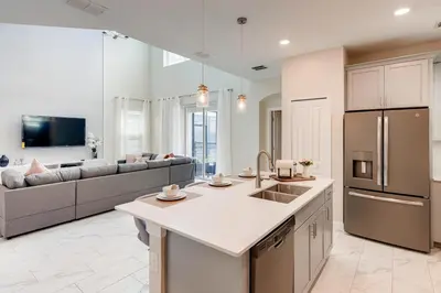 a kitchen and living room with a couch at 2751 BD -Luxury 5BR Single Family - Private Pool in Kissimmee