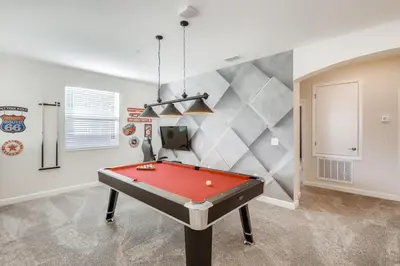 a pool table in a room with a wall at 2773 BD - 5Bd Home with Private Pool 14 Guests in Kissimmee