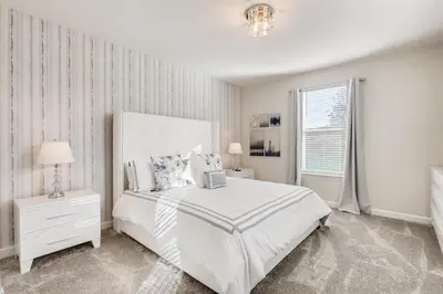 a white bedroom with a bed and a window at 2773 BD - 5Bd Home with Private Pool 14 Guests in Kissimmee