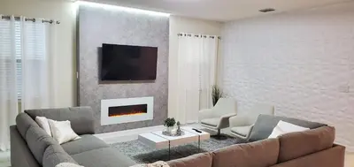 a living room with a couch and a fireplace at 2859 BD - Grand Luxury Villa with a Sparkling Pool in Kissimmee