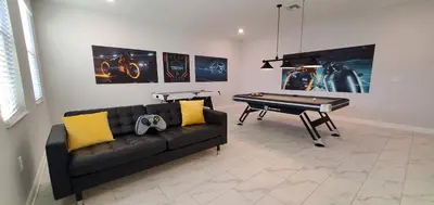 a living room with a couch and a pool table at 2859 BD - Grand Luxury Villa with a Sparkling Pool in Kissimmee