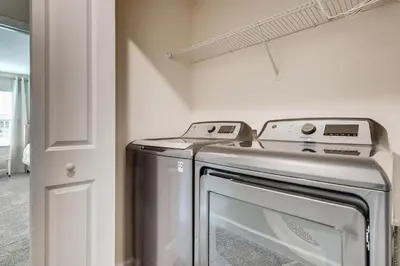 a kitchen with a stainless steel washer and dryer at 4321 QS - Magical Haven Townhome w Pool in Kissimmee