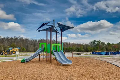 a playground with two slides and an umbrella at 4321 QS - Magical Haven Townhome w Pool in Kissimmee
