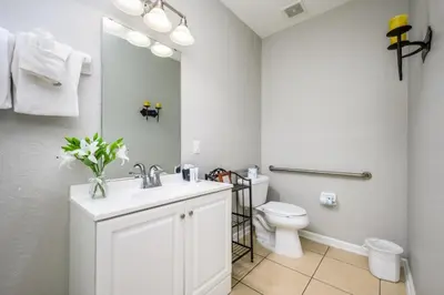 a bathroom with a white sink and a toilet at Epic Universe New Listing Beautiful Townhome, Vista Cay 4019 in Orlando