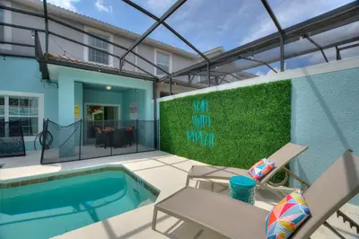 a patio with a swimming pool and a house at Peach Odyssey At Storey Lake By Shine Villas #908 in Kissimmee