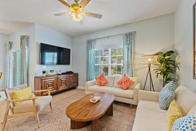 a living room with a couch and a table at Peach Odyssey At Storey Lake By Shine Villas #908 in Kissimmee