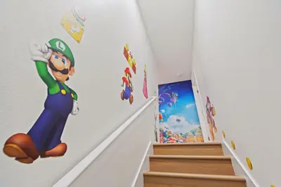 a room with mario kart stickers on the wall at Peach Odyssey At Storey Lake By Shine Villas #908 in Kissimmee