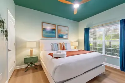 a bedroom with a bed and a window at Peach Odyssey At Storey Lake By Shine Villas #908 in Kissimmee