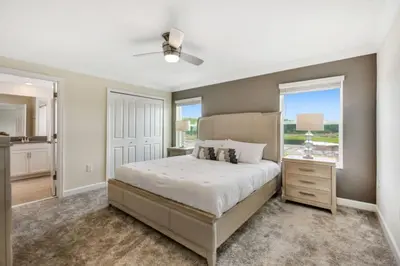a bedroom with a large bed and a window at Magic Lily - Storey Lake By Shine Villas #834 in Kissimmee