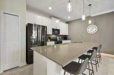 a kitchen with a counter and a refrigerator at Magic Lily - Storey Lake By Shine Villas #834 in Kissimmee
