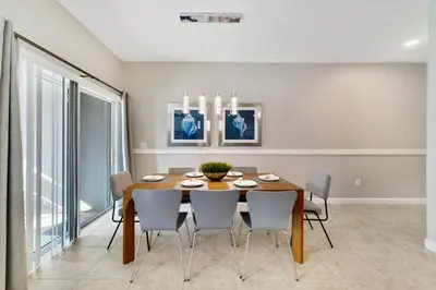 a dining room with a wooden table and chairs at Star Hideaway At Storey Lake By Shine Villas #716 in Kissimmee